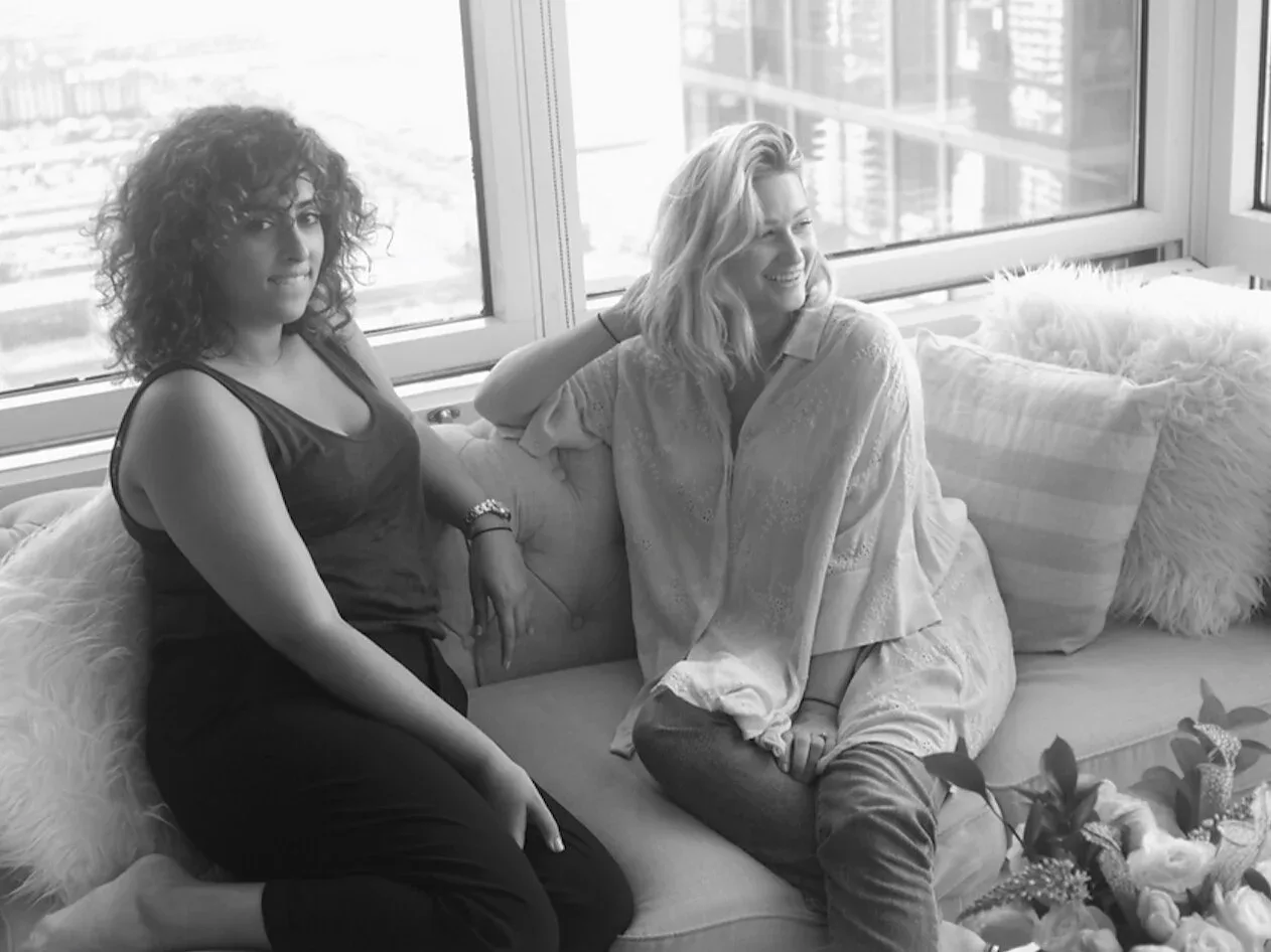 Jasmine Einalhori and Rachel Fuchs Toledano seated together by a window